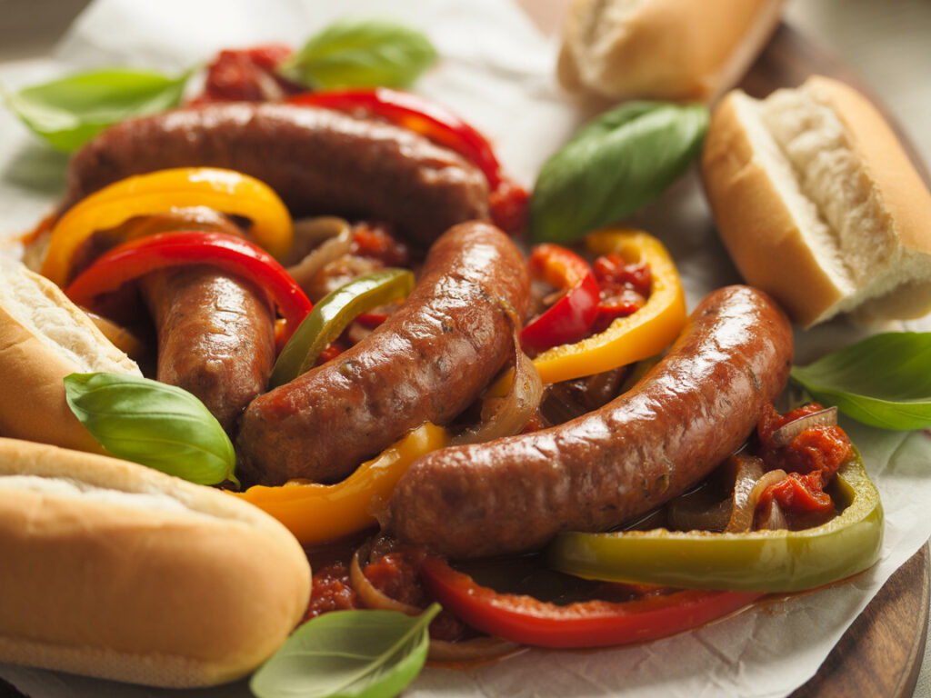 Italian sausages with colorful bell peppers and onions in tomato sauce