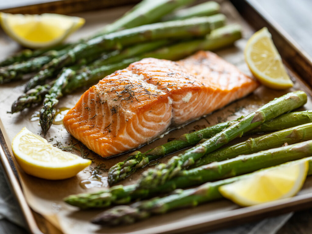 Baked salmon fillet with asparagus and lemon slices on sheet pan