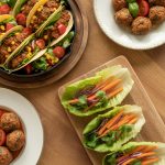 Delicious ground turkey dinner spread with tacos, meatballs, and lettuce wraps on a rustic wooden table