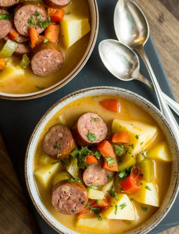 two bowls of cajun potato soup on a table