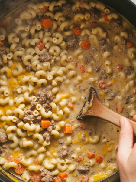 Pot of creamy cheeseburger macaroni soup with elbow pasta, ground beef, and melted cheddar cheese