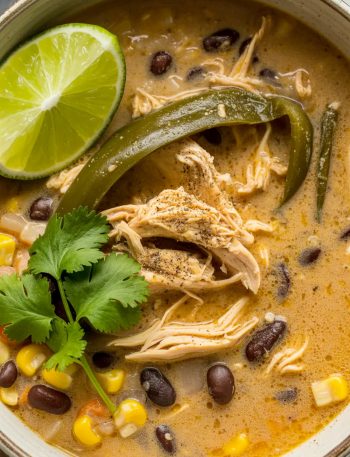 Chicken poblano and black bean soup with shredded chicken, corn, black beans, and fresh cilantro in creamy broth