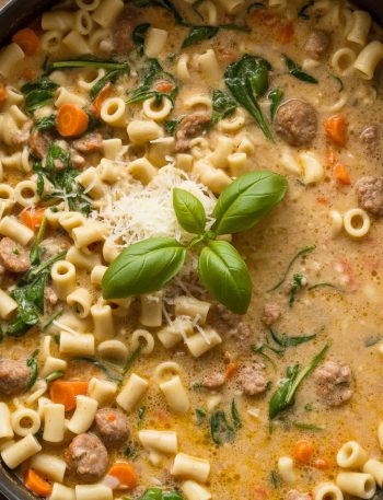 Pot of creamy Parmesan ditalini soup with Italian sausage, pasta, and spinach in rich broth