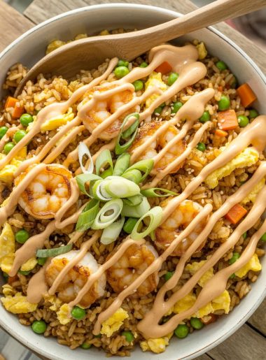 Large serving bowl of colorful bang bang fried rice with golden caramelized shrimp, scrambled eggs, peas, carrots, and green onions
