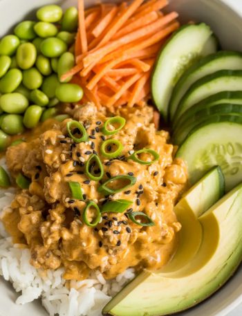 Ground turkey bang bang rice bowl with creamy sauce, vegetables and rice in white bowl