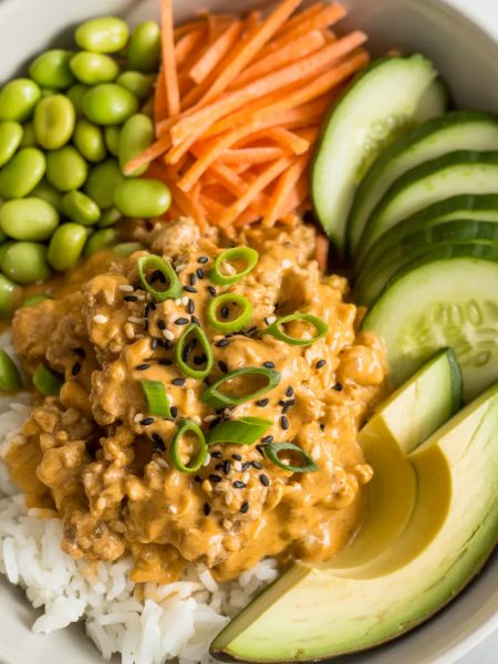 Ground turkey bang bang rice bowl with creamy sauce, vegetables and rice in white bowl